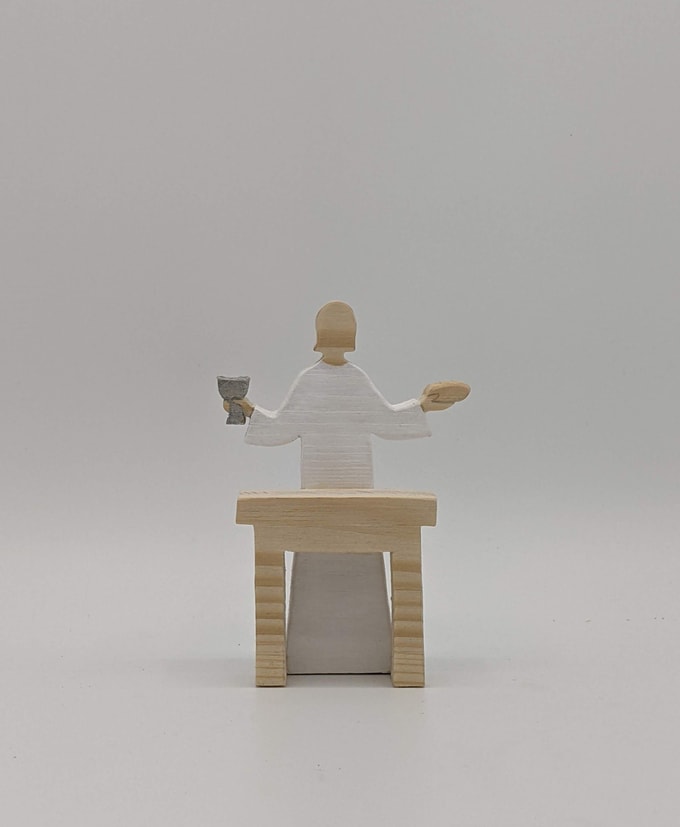 Jésus présentant le pain et le vin devant table
